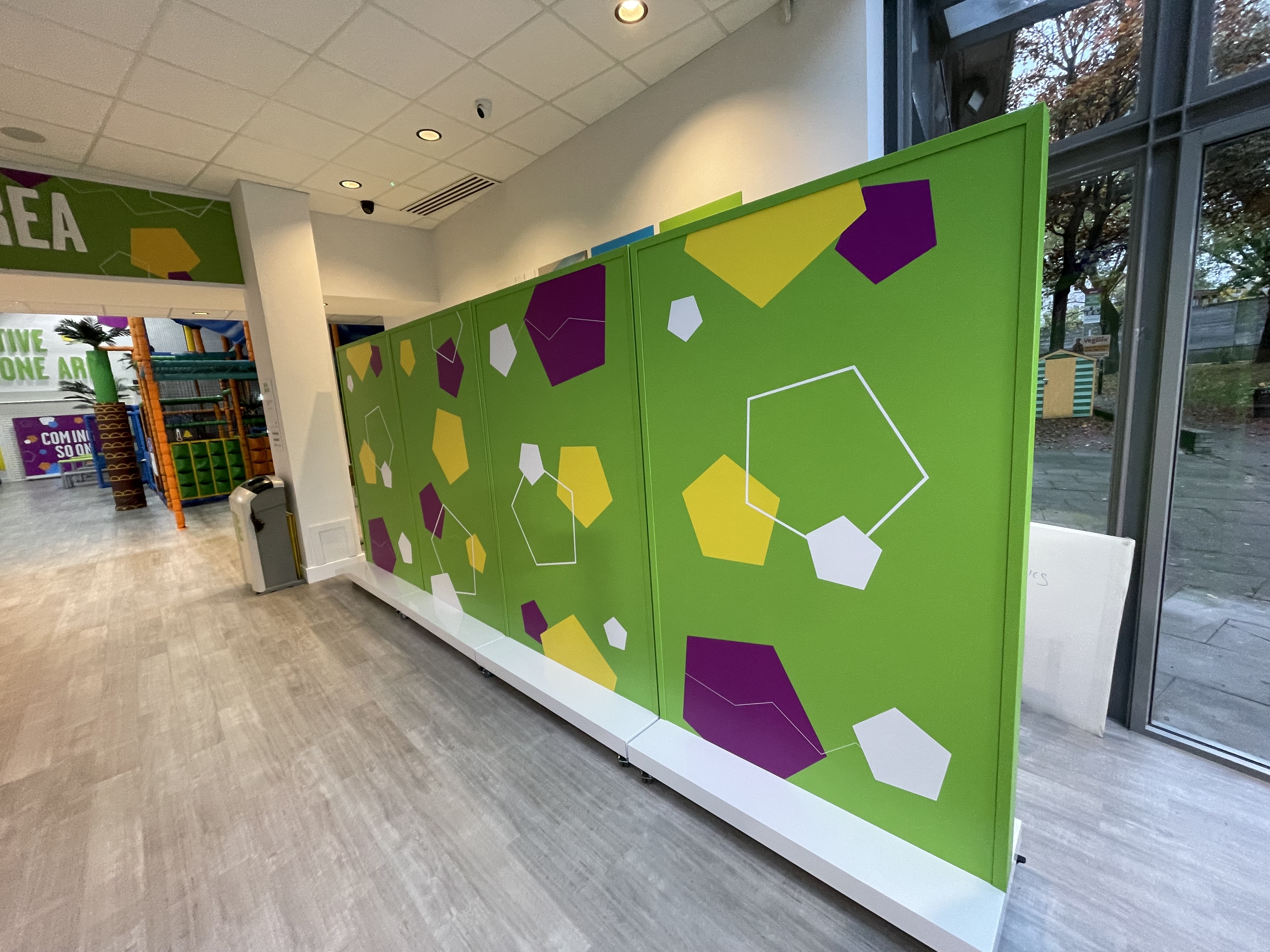 Branded green exhibition walls dividing an indoor exhibition space