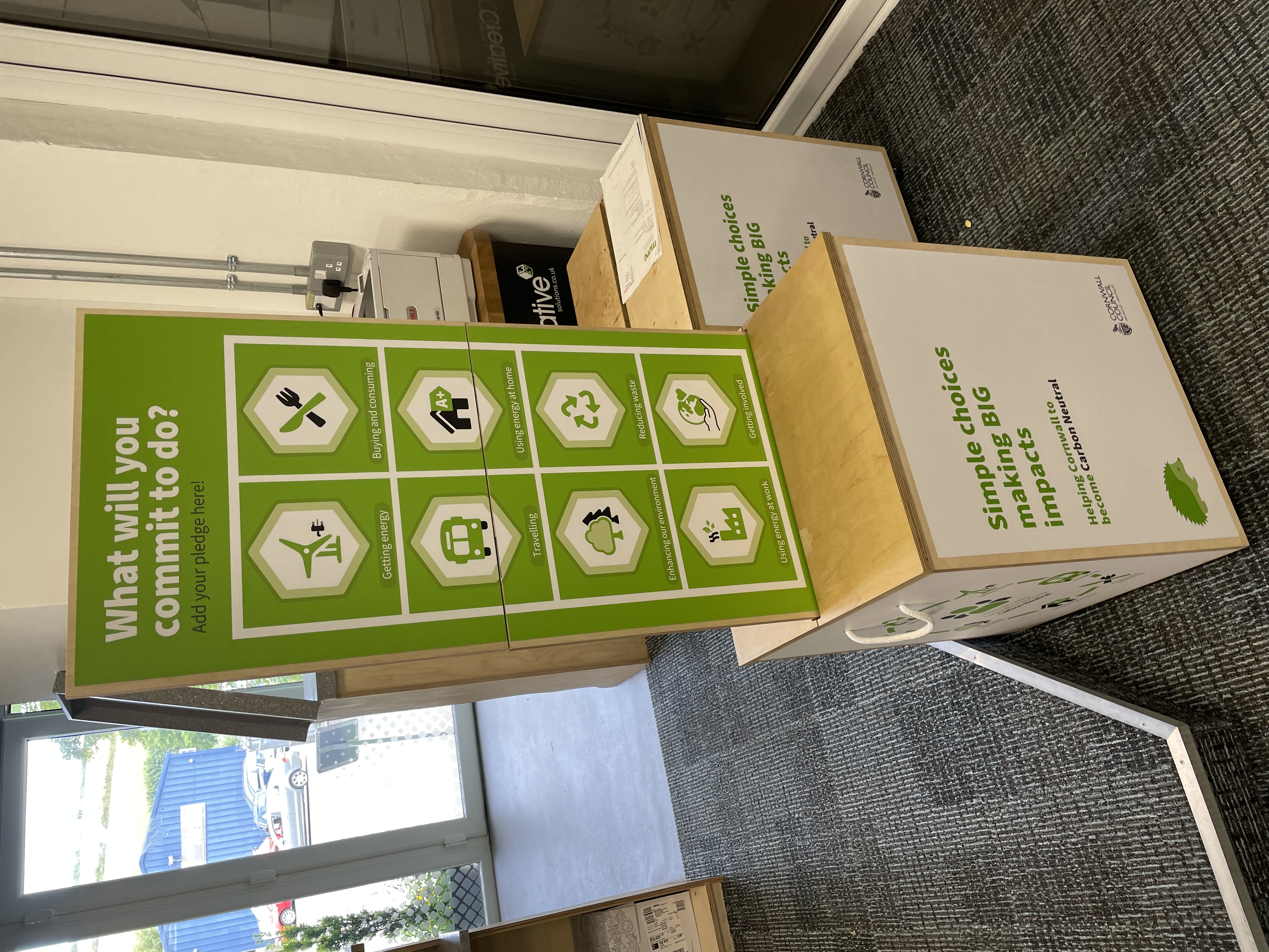 Fully assembled Cornwall Council branded popup exhibition stand on its wooden storage cube