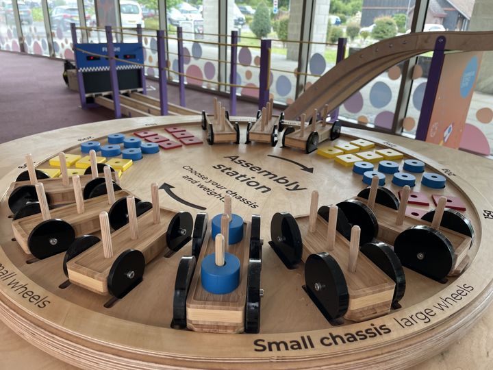 Build & Race Car Track: model cars and components arranged around the circular worktop.