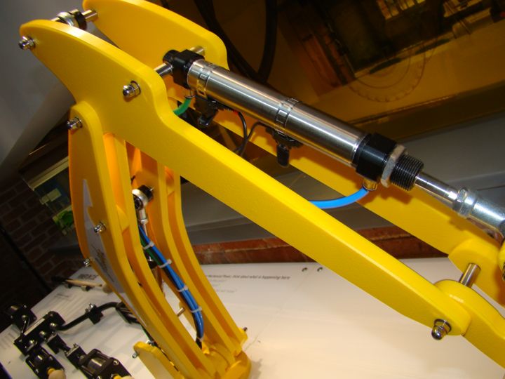 Close-up of the arm mechanism and pneumatic connections.