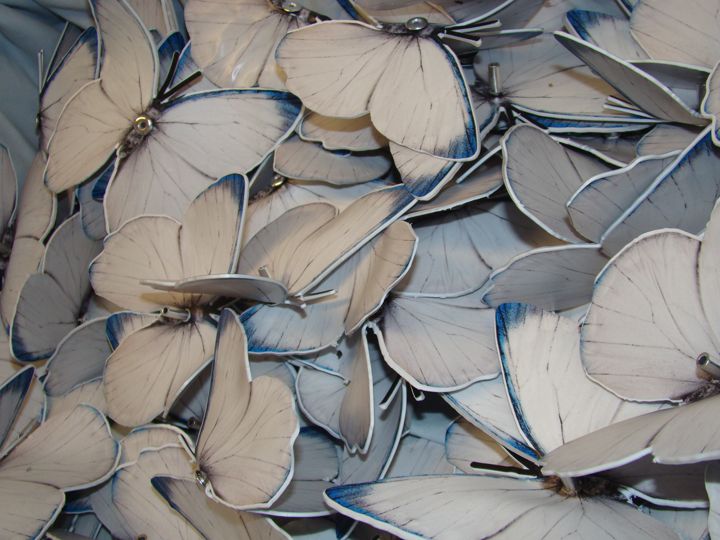 CNC-machined butterfly shapes before forming and assembly.