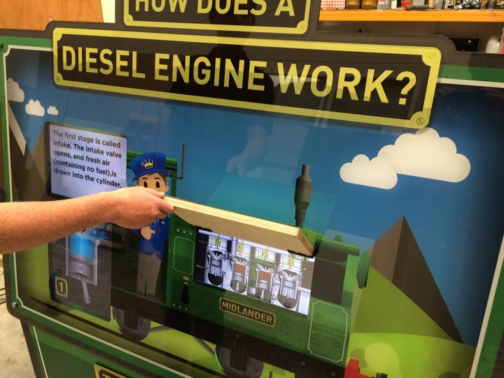 Lifting the bonnet to reveal the animated diesel engine.