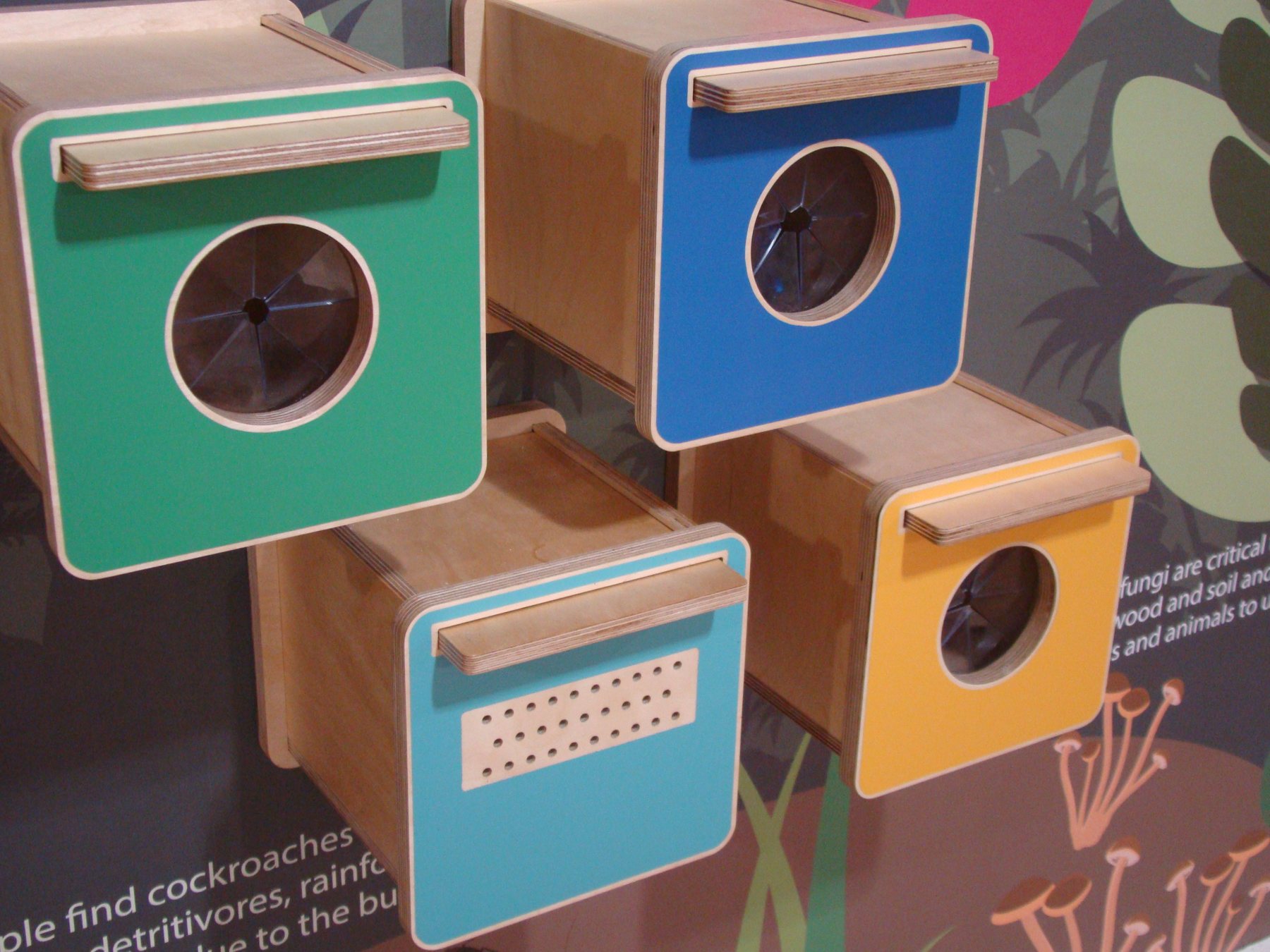 Colourful touch-and-feel boxes arranged at different heights.