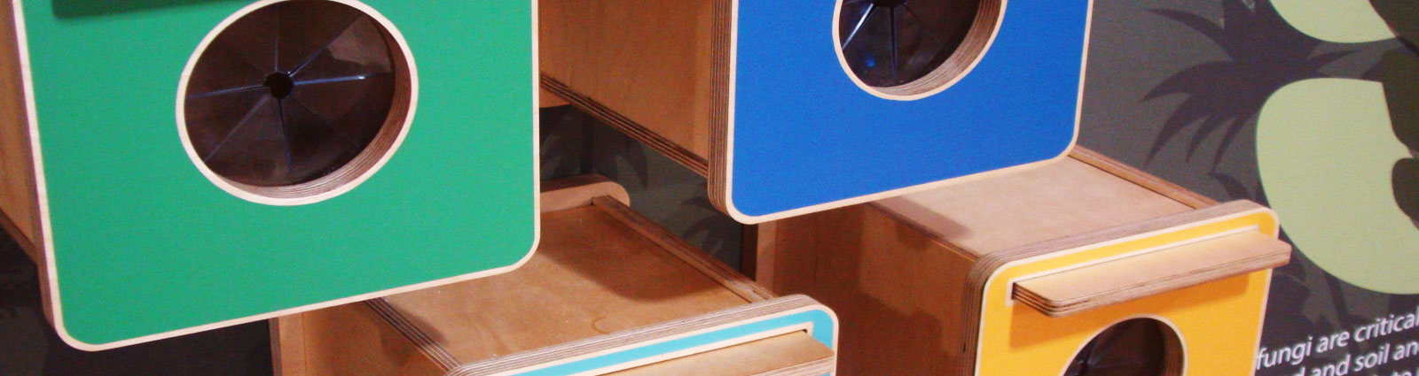Colourful touch-and-feel boxes arranged at different heights.