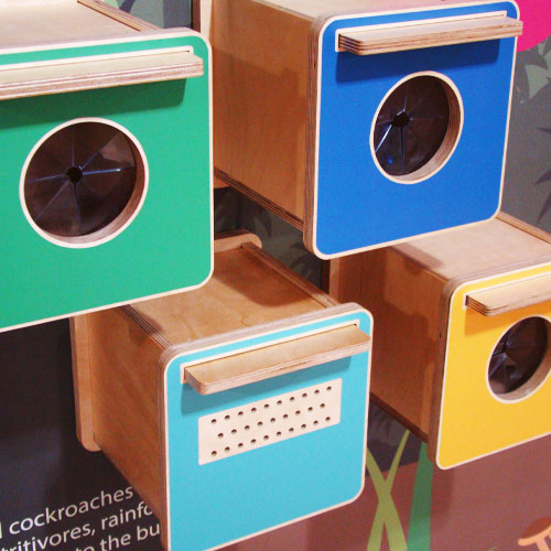 Colourful touch-and-feel boxes arranged at different heights.