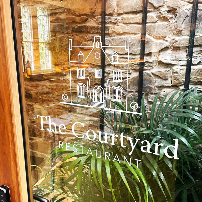 The Courtyard restuarant signage in Bodmin with detailed window vinyl graphics 