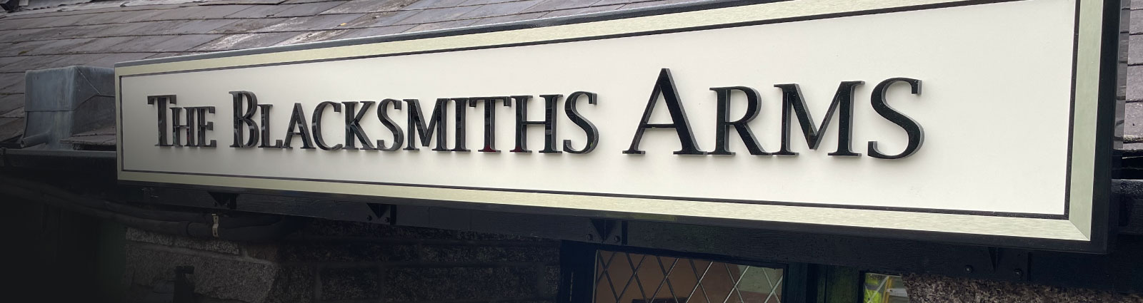 Quality pub signage with black raised lettering on cream background in Tavistock