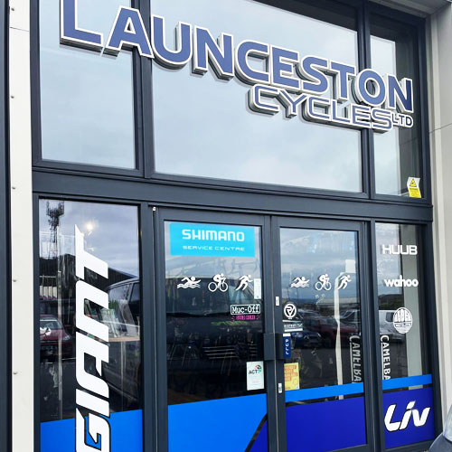 Launceston cycles shop sign letters bonded to glass window  in Launceston Cornwall