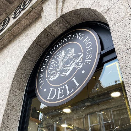 Bronze deli circular sign with logo | More Creative