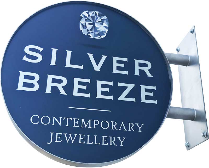 Custom fabricated stainless steel projecting sign with printed graphics