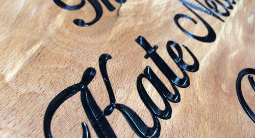 Carved wooden signs with paint infilled text