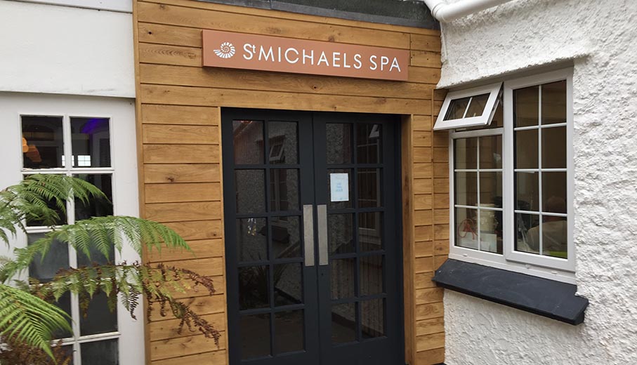 illuminated copper sign above entrance doors