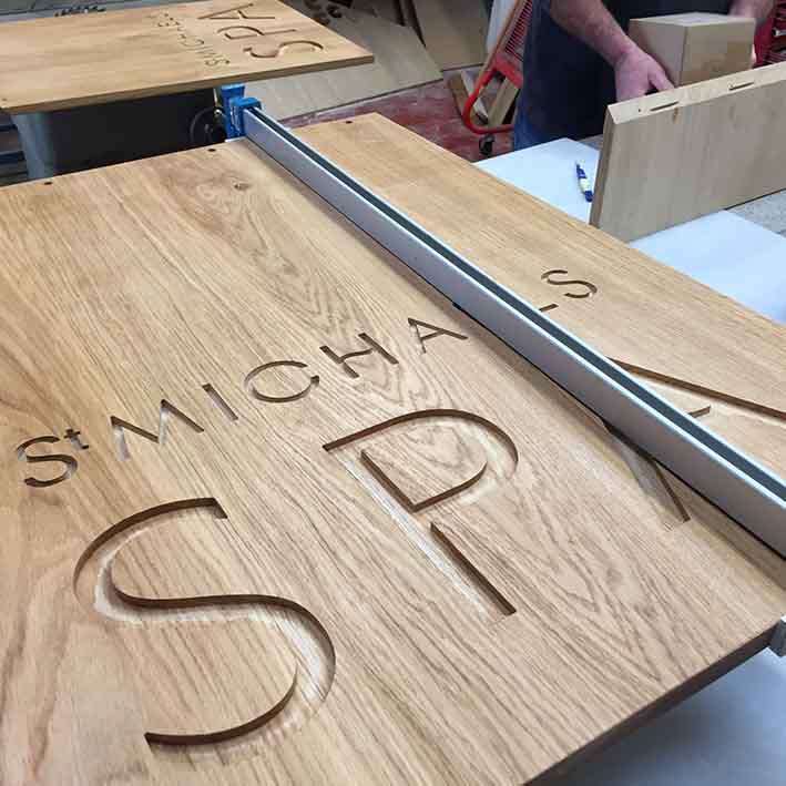 CNC carved logo into oak desk front features 