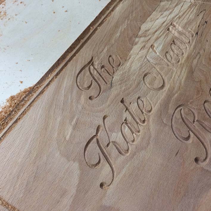 CNC carved text into wooden sign
