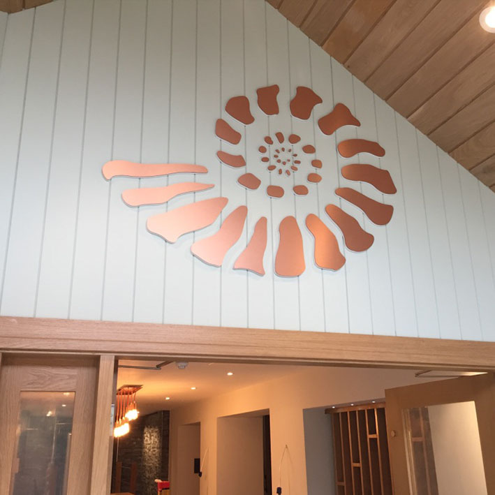 Custom wall logo feature in copperat hotel in Falmouth