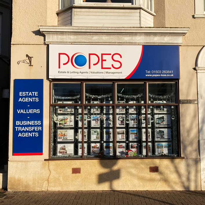 Shop signs in Looe for Popes Estate Agents